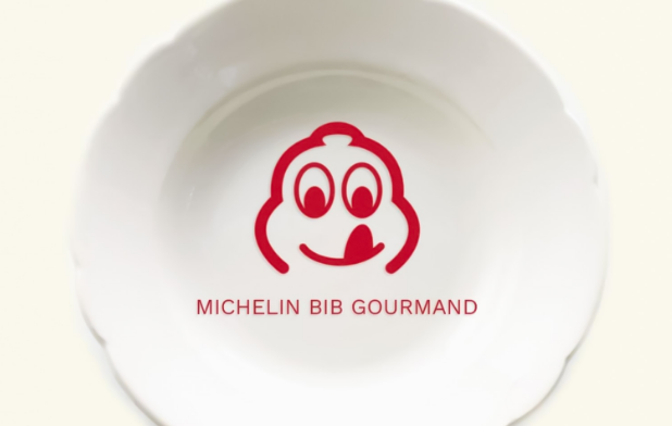 Red Michelin Man Bib Gourmand logo licking its lips with text reading MICHELIN BIB GOURMAND 2025 on a white background