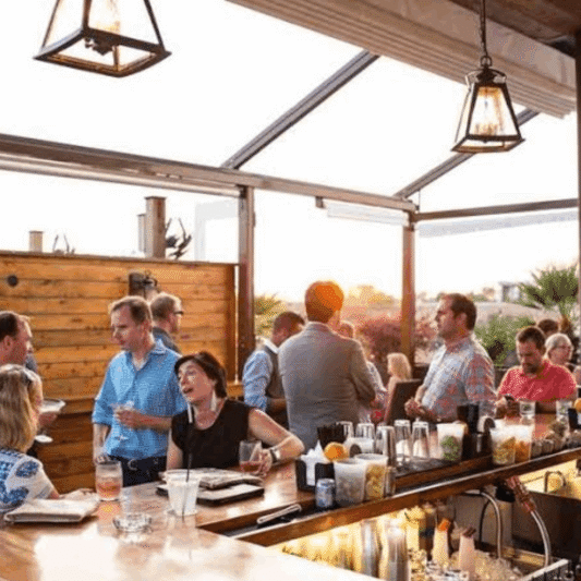 Guests enjoying cocktails at a rooftop bar in Charleston