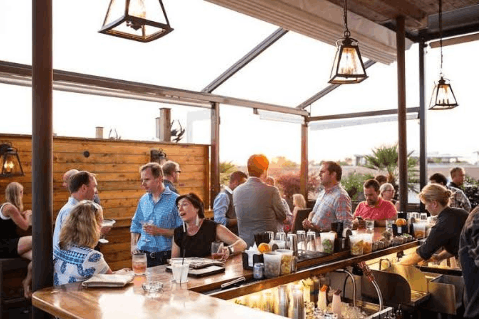 Guests enjoying cocktails at a rooftop bar in Charleston