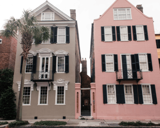Historic Rainbow Row pastel-colored houses on East Bay Street in Charleston, South Carolina.