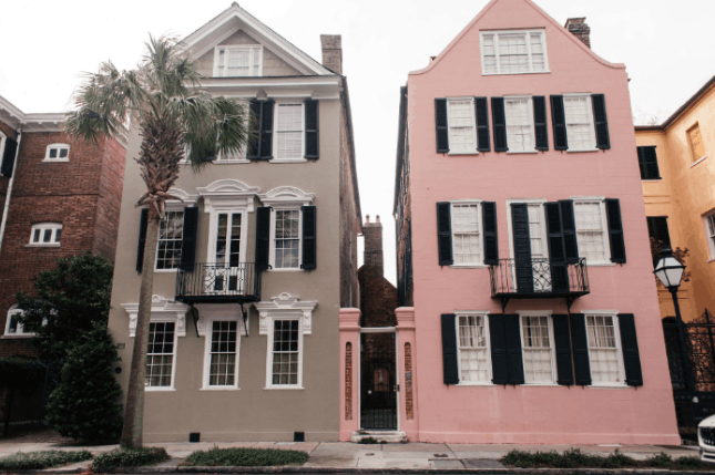 Historic Rainbow Row pastel-colored houses on East Bay Street in Charleston, South Carolina.