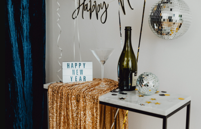 A festive New Year's Eve setup featuring champagne, disco balls, and celebratory decor. A festive New Year's Eve setup featuring champagne, disco balls, and celebratory decor.