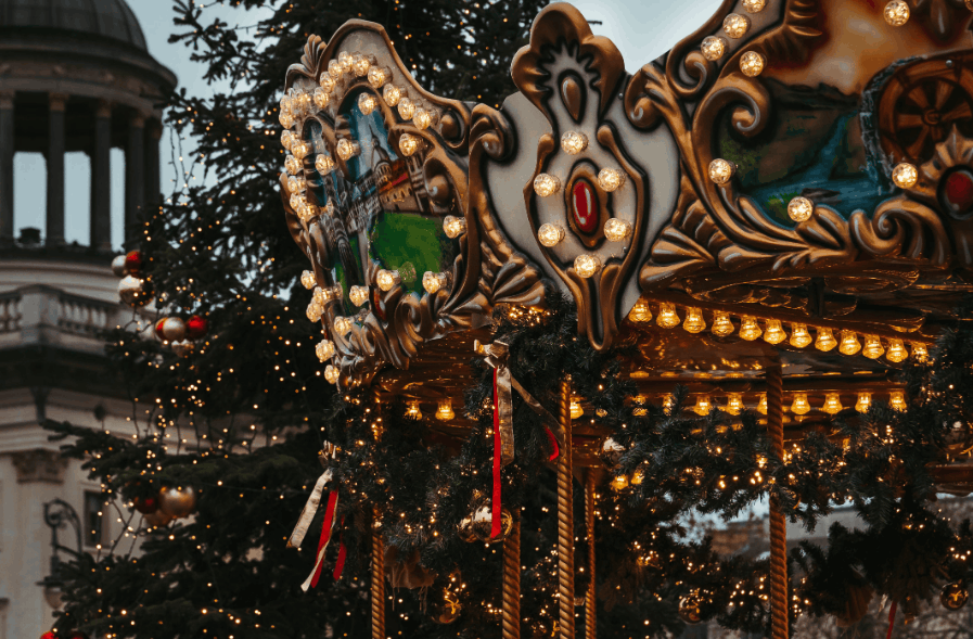Colorful carousel and Christmas lights create a festive holiday atmosphere